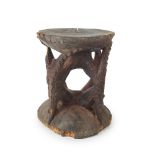 SEPIK RIVER STOOL carved wood and pigment, the gently curving seat supported by four crocodile