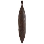ABORIGINAL BROAD SHIELD carved wood, tapering to a point at one end, decorated with rhythmical