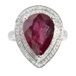 A ruby and diamond set cocktail ringclaw set with a pear shaped ruby in a double border of round