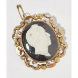 A mid-Victorian cameo pendantof oval outline, the central glass cameo dpeciting Rev. William