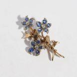 A sapphire and diamond set floral spray broochmodelled as three flowers in bloom, each set with an