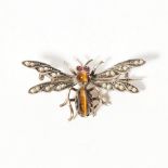 A gem set insect broochmodelled as a winged beetle, set with seed pearls and tiger's eye