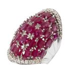 A large modern ruby and diamond set dress ringof domed design, claw set throughout with graduated