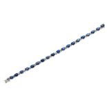 An 18ct gold sapphire and diamond set line braceletclaw set with a single row of nineteen oval cut