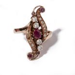 A ruby and diamond set ringof scrolling navette outline, claw set with a pear shaped ruby and four