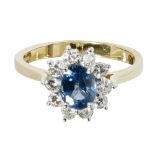 A sapphire and diamond set cluster ringclaw set with an oval cut sapphire, in a border of round