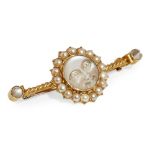 A moonstone and pearl set bar broochcollet set with a moonstone carved as a face in a border of half