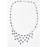 A sapphire set fringed necklacecollet set with a single row of oval and round cut sapphires, the