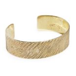 A contemporary silver gilt bangle, Adrian Gerald Benneyof plain broad design, with textured finish