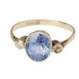 A sapphire and diamond set three stone ringmillegrain set with an oval cut sapphire, flanked by