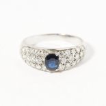 A sapphire and diamond set ringclaw set with an oval sapphire in a surround pavé set with