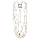 A pearl and diamond set necklacecomposed of three rows of graduated cultured pearls, with two