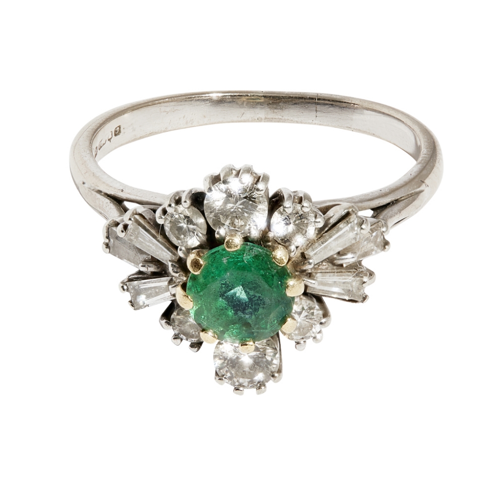 An emerald and diamond set ringclaw set with a round-cut emerald, in a border of graduated round-cut