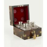 A brass bound rosewood cased set of cut crystal small bottlesthe silver screw-off covers decorated