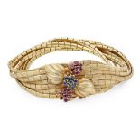 A mid 20th-century ruby and diamond set braceletcomposed of seven strands of textured links, the