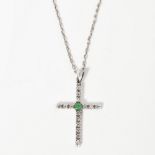 A diamond and emerald set pendant crossof traditional form, claw set to the centre with a round