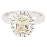 A yellow sapphire and diamond set cluster ringclaw set with a scissor-cut yellow sapphire, in a