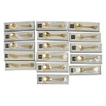 A collection of sixteen Georg Jensen silver gilt year spoonssilver gilt and enamel, various years,