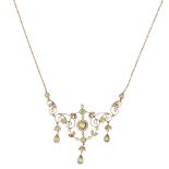 An early 20th century seed pearl and peridot set necklaceof pierced scrolling design, set throughout