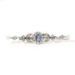 A sapphire and diamond set bar broochclaw set with an oval-cut sapphire in a border of rose-cut