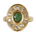 An emerald and diamond set cluster ringcollet set with a round-cut emerald, in an oval border set