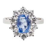 A sapphire and diamond set cluster ringclaw set with a mixed cushion-cut sapphire, in a border of