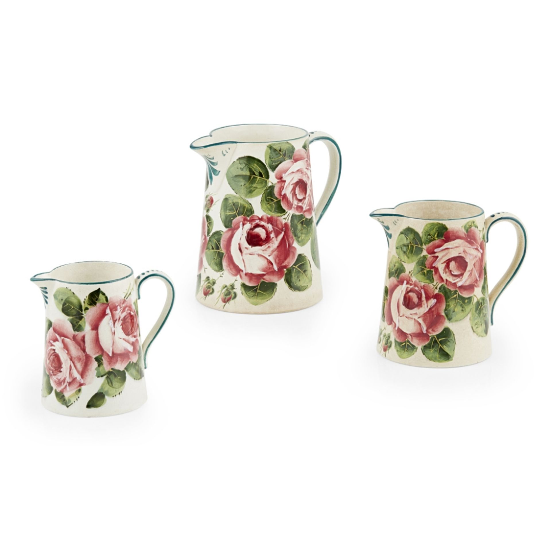 WEMYSS WARE SET OF THREE 'CABBAGE ROSES' GRADUATED JUGS, EARLY 20TH CENTURY each with maker's