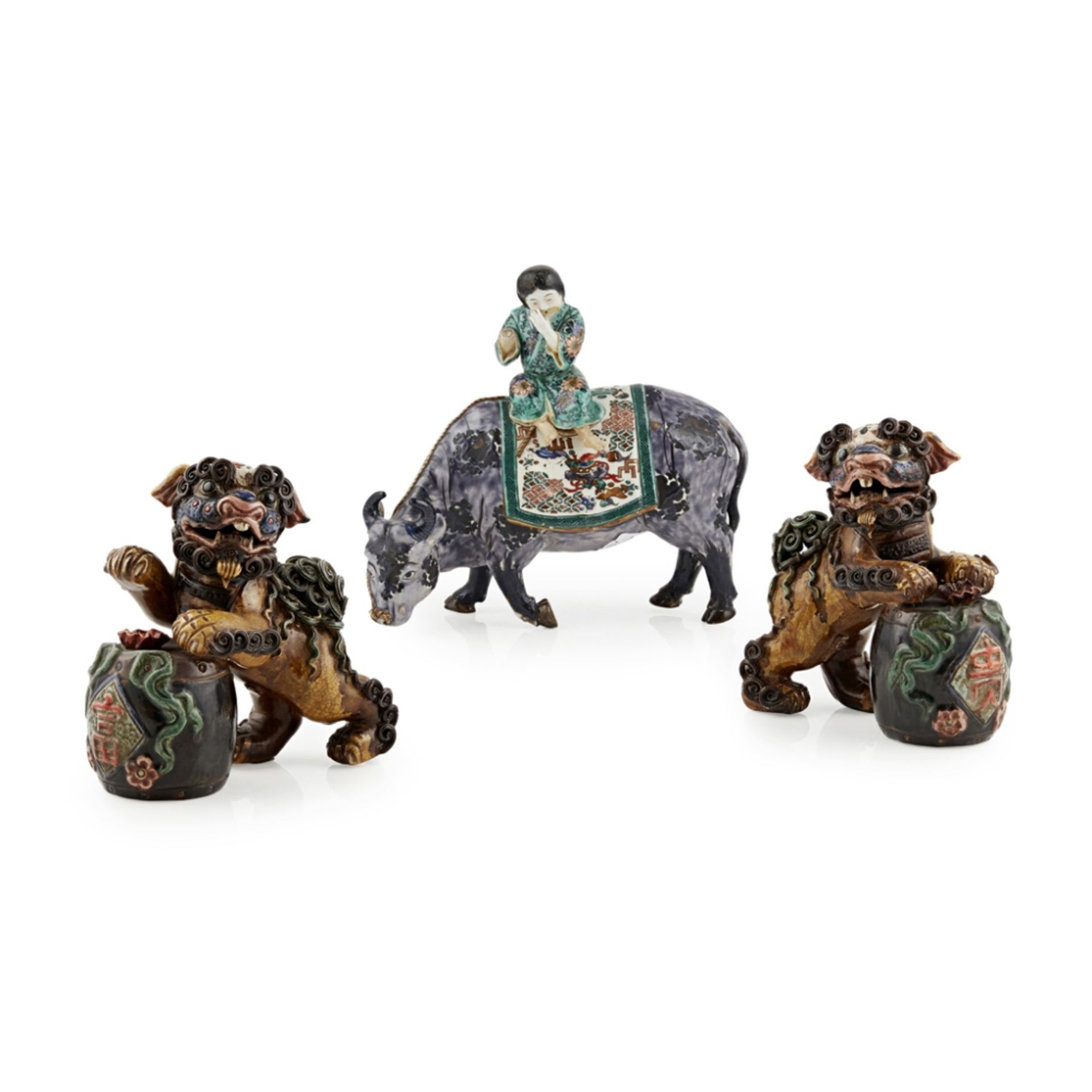 PAIR OF GLAZED POTTERY BUDDISTIC LIONSLATE QING DYNASTY with applied scrolling 'hair' and polychrome