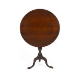 GEORGIAN TILT-TOP MAHOGANY TABLE18TH CENTURY the circular top on a baluster column and tripod base