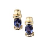 A pair of contemporary Tanzanite and diamond set earringseach set with an oval cut Tanzanite,