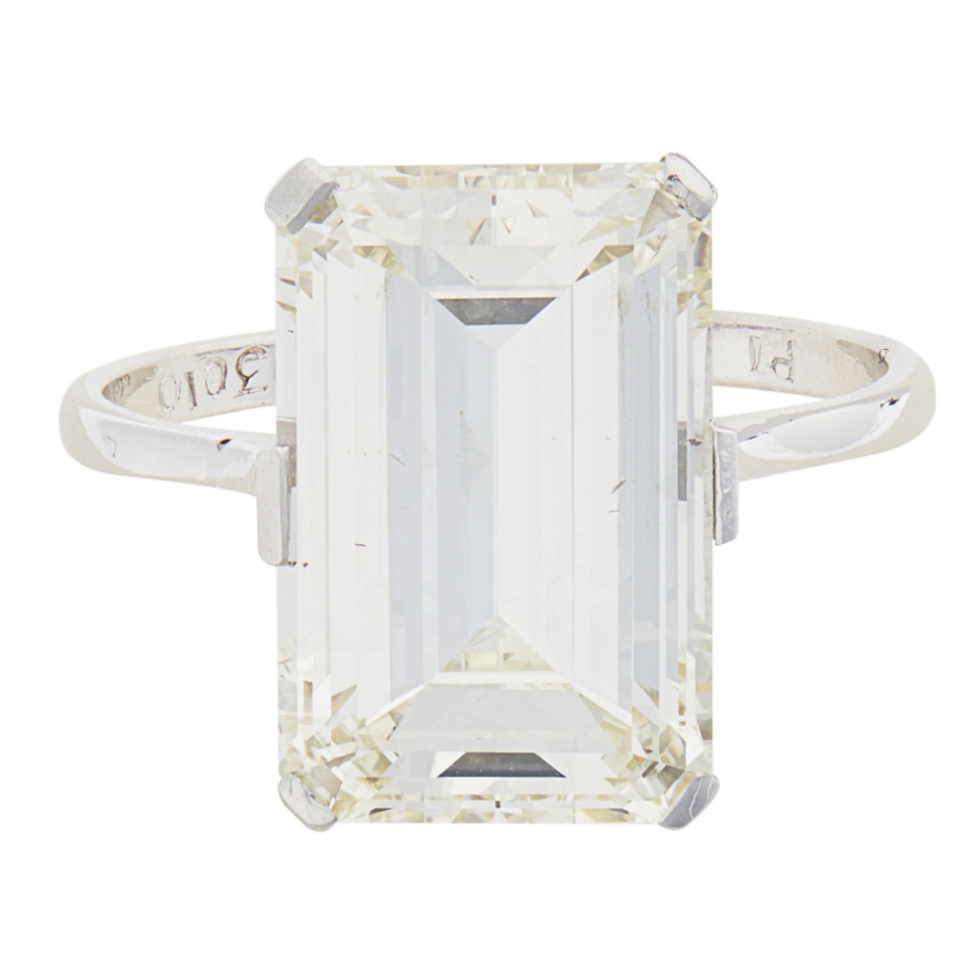 A single stone diamond ringclaw set with a single trap cut diamond, to a plain unmarked white