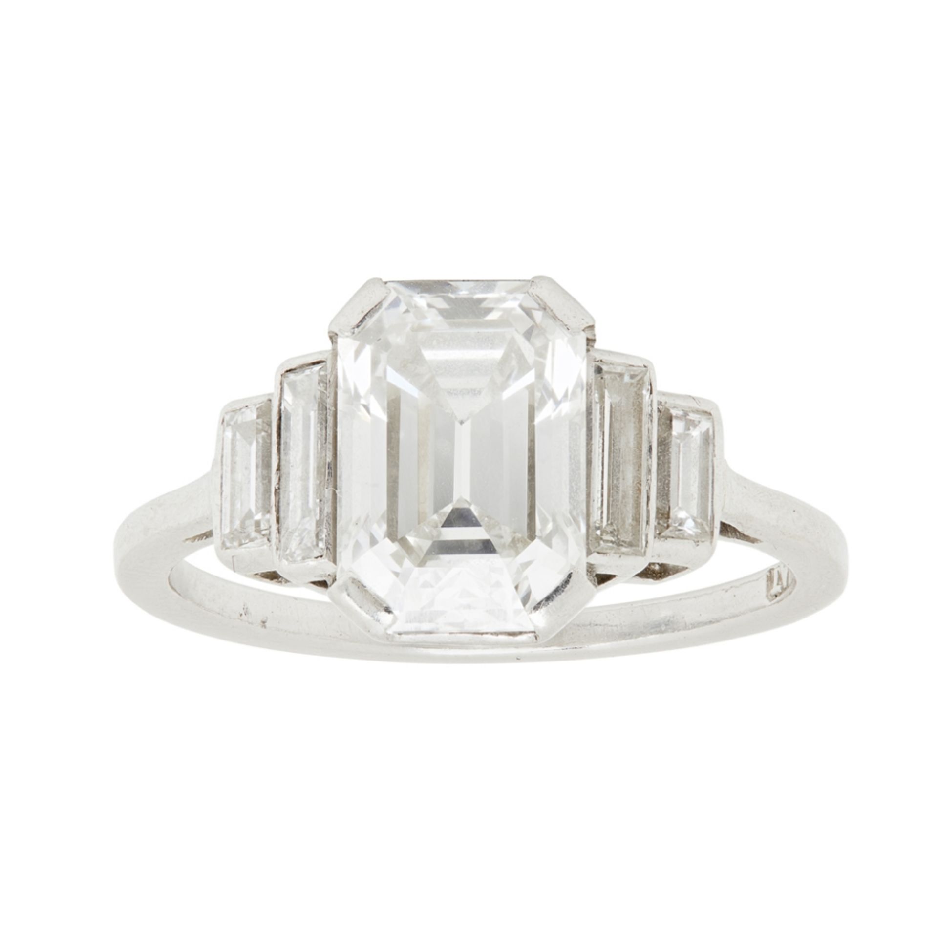 A 1940s single stone diamond ringclaw set with a trap cut diamond, flanked to either side by two