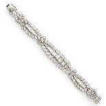 A 1940s/1950s diamond set braceletchannel set with a central row of tapered baguette cut diamonds,