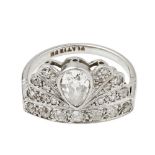 A 1920s diamond set ringmodelled as a fan, millegrain set with a pear shaped diamond, the surround