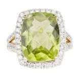 A peridot and diamond set cluster ringclaw set with a cushion mixed cut peridot, in a single