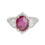 A ruby and diamond set cluster ringclaw set with an oval cut ruby flanked to either side by a pear