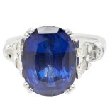 A sapphire and diamond set cocktail ringclaw set with a cushion cut sapphire, each shoulder set with