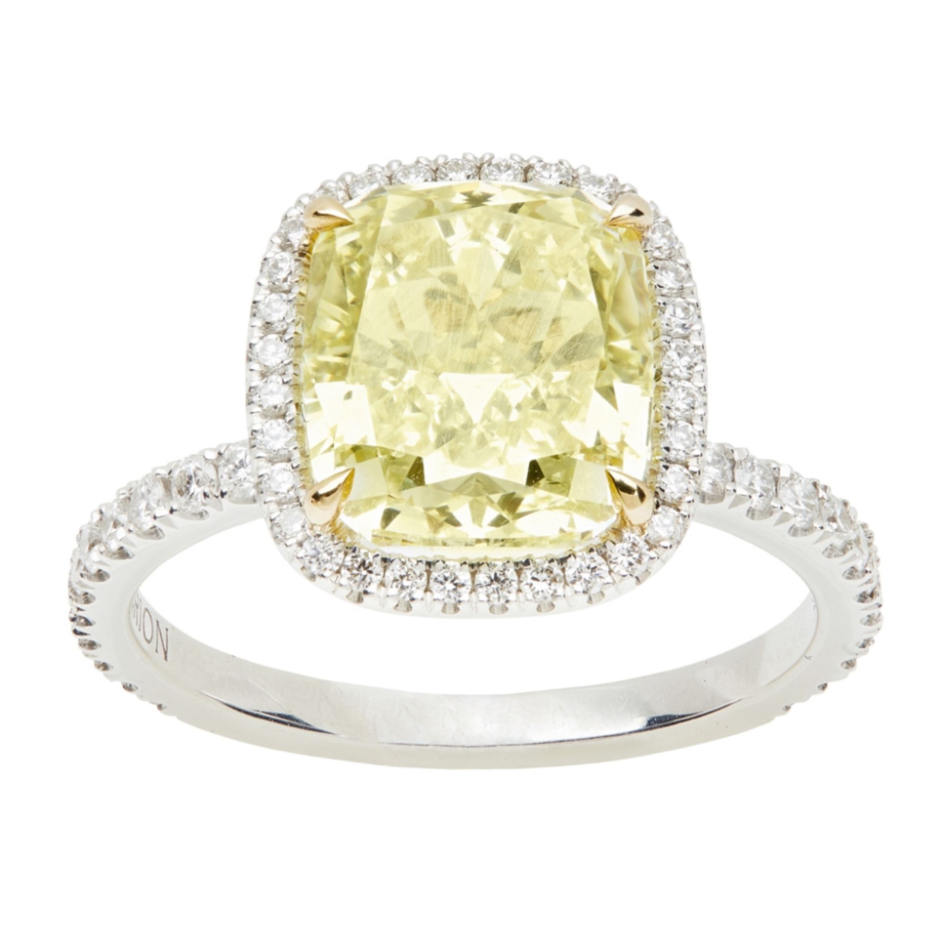 A yellow and colourless diamond set ringclaw set with a cushion cut fancy light yellow diamond, in a