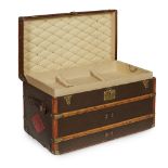An early 20th century Louis Vuitton leather banded courier trunk LV monogram canvas with monogram