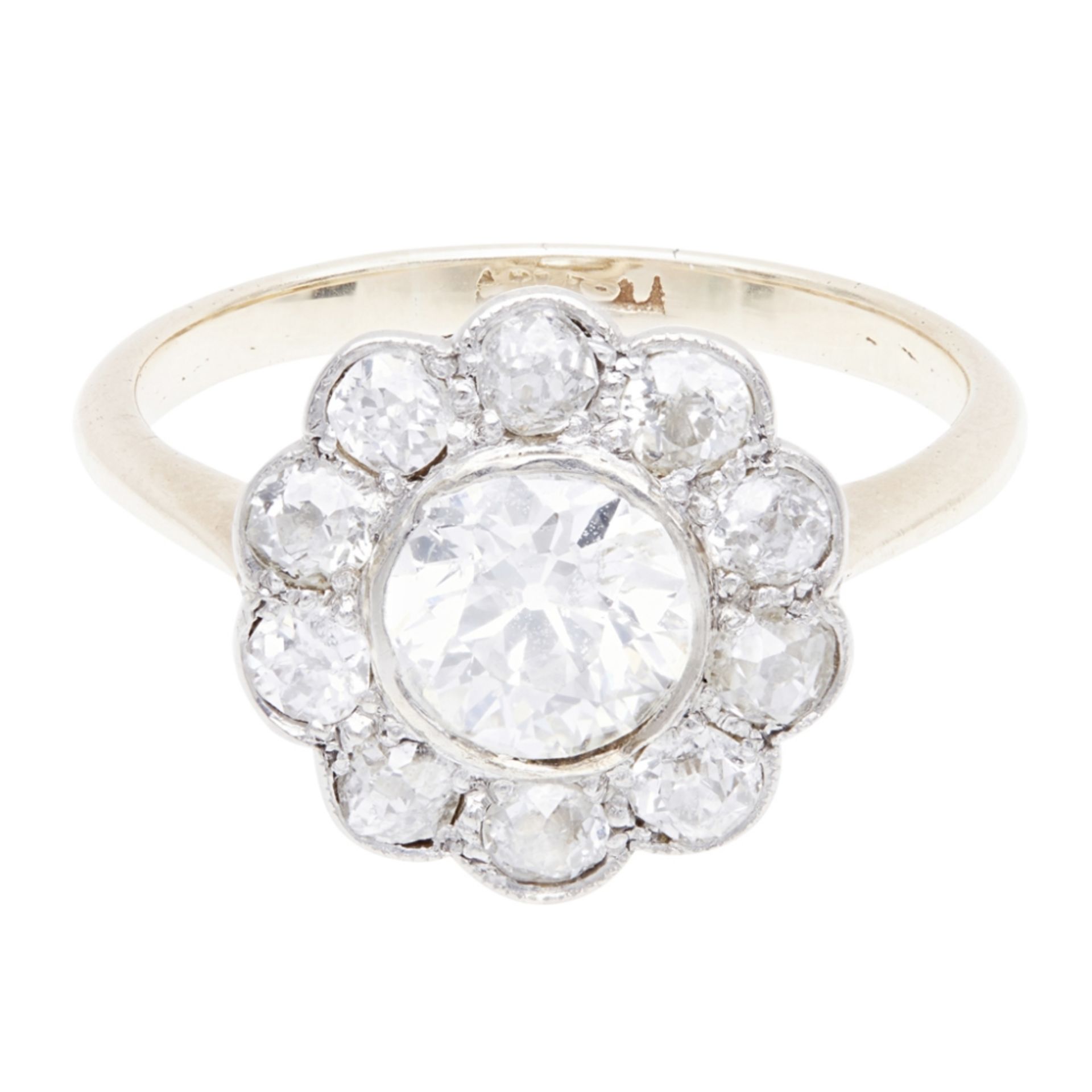 An early 20th century diamond set cluster ring collet set with an old-round cut diamond, in a border