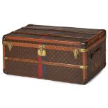 A Louis Vuitton striped trunk covered in signature monogram canvas with brown leather trim, wood