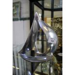 A contemporary cast polished aluminium model of a sailing yacht