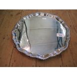 A silver salver with ribbed edge of four ball and claw feet, Sheffield 1972