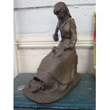 An attractive bronzed figure study of a young girl seated sewing, 33cm high