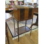 An early 19th century inlaid rosewood domed box on stand, the twin hinged top on canted legs
