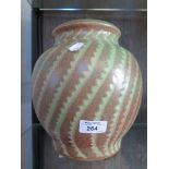 A Royal Doulton stoneware vase, with green serrated spiral pattern, stamped no.57 and signed by Vera