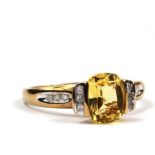 A diamond and yellow stone ring (possibly sapphire) set in 9 carat gold