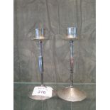 A pair of small Arts and Crafts style silver candlesticks, London 1975
