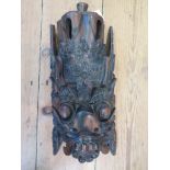 A carved Lignum Vitae 'Devil' mask, possibly Bali, 36cm high