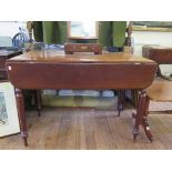 A Victorian mahogany Pembroke table, with drop leaves over a frieze drawer on turned tapering